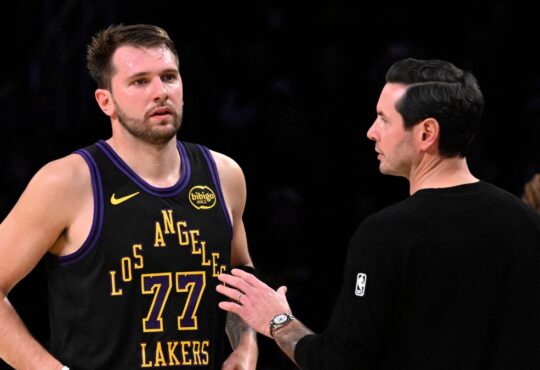 Los Angeles Lakers head coach JJ Redick talks with Luka Doncic #77 during a game against the Utah Jazz at Crypto.com Arena on November 18, 2025.