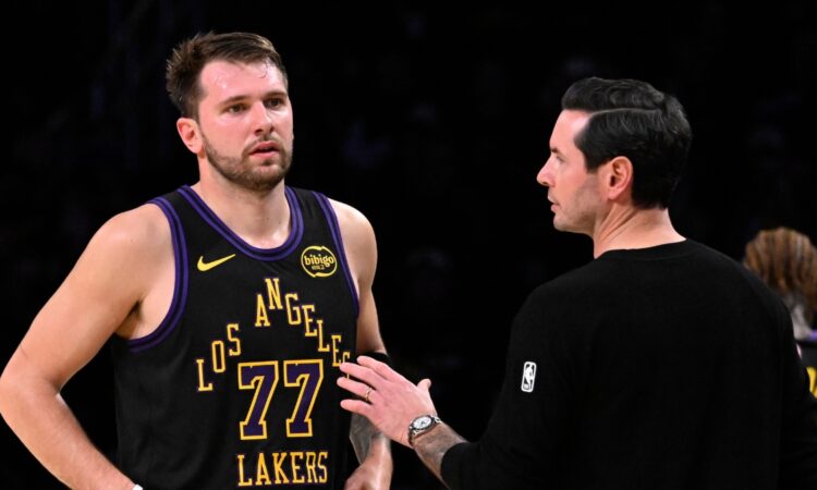 Los Angeles Lakers head coach JJ Redick talks with Luka Doncic #77 during a game against the Utah Jazz at Crypto.com Arena on November 18, 2025.