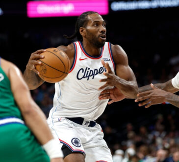 Kawhi Leonard #2 of the Los Angeles Clippers drives to the basket against Naji Marshall #13 of the Dallas Mavericks during overtime at American Airlines Center.