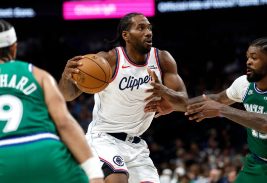 Kawhi Leonard #2 of the Los Angeles Clippers drives to the basket against Naji Marshall #13 of the Dallas Mavericks during overtime at American Airlines Center.