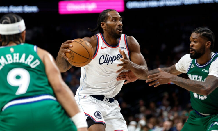 Kawhi Leonard #2 of the Los Angeles Clippers drives to the basket against Naji Marshall #13 of the Dallas Mavericks during overtime at American Airlines Center.