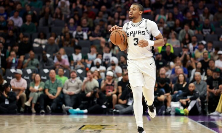 Keldon Johnson #3 of the San Antonio Spurs dribbles the ball during a game against the Sacramento Kings at Golden 1 Center on March 17, 2026.