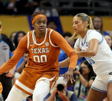 Kyla Oldacre #00 of the Texas Longhorns drives to the basket against Sienna Betts of the UCLA Bruins during the 2026 NCAA Women's Final Four in Phoenix.