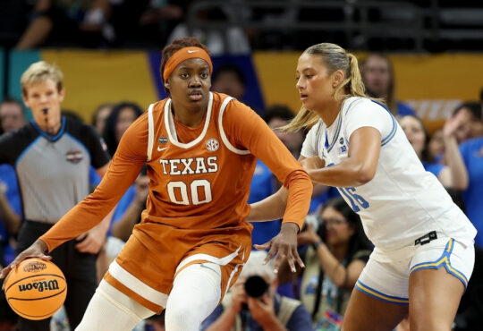 Kyla Oldacre #00 of the Texas Longhorns drives to the basket against Sienna Betts of the UCLA Bruins during the 2026 NCAA Women's Final Four in Phoenix.