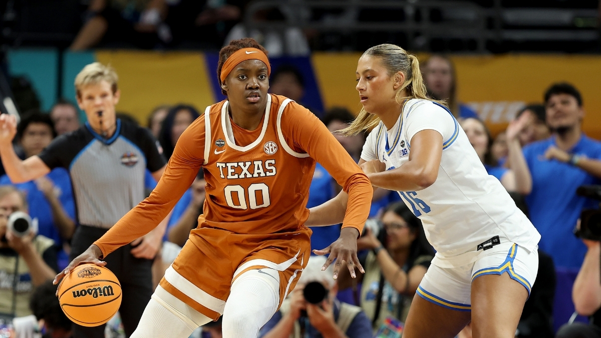 Kyla Oldacre #00 of the Texas Longhorns drives to the basket against Sienna Betts of the UCLA Bruins during the 2026 NCAA Women's Final Four in Phoenix.