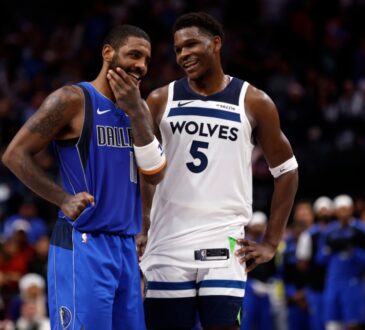 Kyrie Irving #11 of the Dallas Mavericks and Anthony Edwards #5 of the Minnesota Timberwolves talk during the Christmas Day game at American Airlines Center on December 25, 2024.