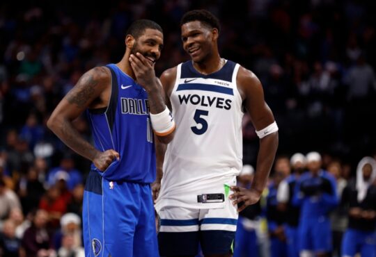Kyrie Irving #11 of the Dallas Mavericks and Anthony Edwards #5 of the Minnesota Timberwolves talk during the Christmas Day game at American Airlines Center on December 25, 2024.
