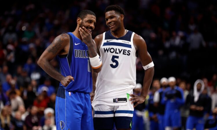 Kyrie Irving #11 of the Dallas Mavericks and Anthony Edwards #5 of the Minnesota Timberwolves talk during the Christmas Day game at American Airlines Center on December 25, 2024.