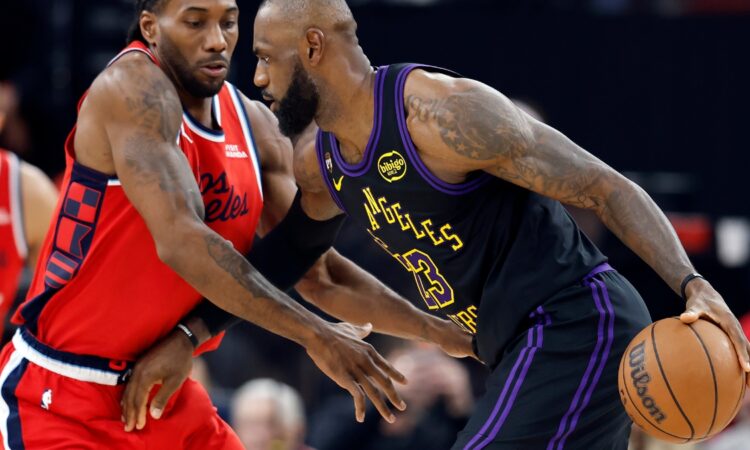 LeBron James #23 of the Los Angeles Lakers controls the ball against Kawhi Leonard #2 of the Los Angeles Clippers at Intuit Dome on January 22, 2026.