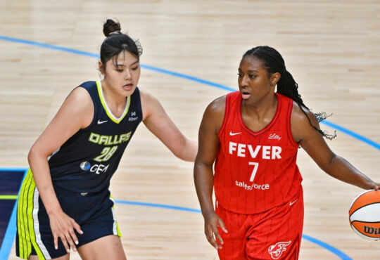 Dallas Wings center Li Yueru defends Indiana Fever center Aliyah Boston in the post during a game at American Airlines Center.