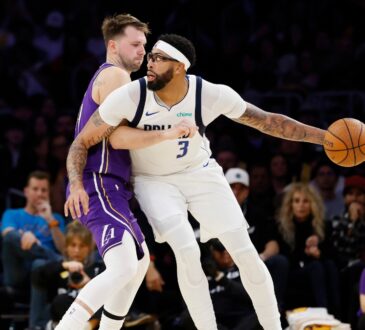 Luka Doncic #77 of the Los Angeles Lakers guards Anthony Davis #3 of the Dallas Mavericks at Crypto.com Arena on November 28, 2025.