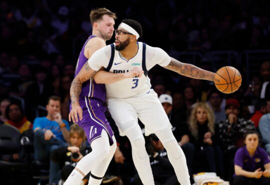 Luka Doncic #77 of the Los Angeles Lakers guards Anthony Davis #3 of the Dallas Mavericks at Crypto.com Arena on November 28, 2025.