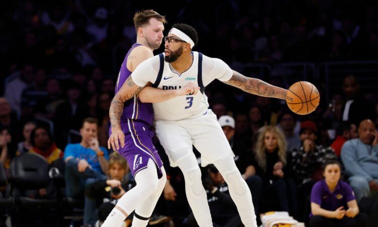 Luka Doncic #77 of the Los Angeles Lakers guards Anthony Davis #3 of the Dallas Mavericks at Crypto.com Arena on November 28, 2025.