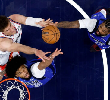 Marvin Bagley III #35 and Naji Marshall #13 of the Dallas Mavericks battle Brook Lopez #11 of the Los Angeles Clippers for a rebound during the first half at Intuit Dome.