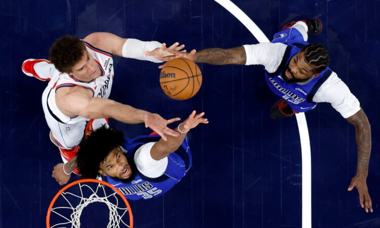 Marvin Bagley III #35 and Naji Marshall #13 of the Dallas Mavericks battle Brook Lopez #11 of the Los Angeles Clippers for a rebound during the first half at Intuit Dome.