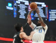 Naji Marshall #13 of the Dallas Mavericks takes a jumper over Deni Avdija #8 of the Portland Trail Blazers during an NBA game at the Moda Center.
