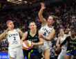 Paige Bueckers of the Dallas Wings drives to the basket against Alanna Smith and Natisha Hiedeman of the Minnesota Lynx.