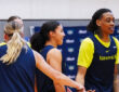 Dallas Wings guards Paige Bueckers, Azzi Fudd, and Zee Spearman on the practice court during training camp in Arlington.