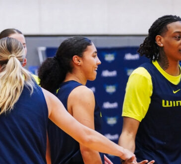 Dallas Wings guards Paige Bueckers, Azzi Fudd, and Zee Spearman on the practice court during training camp in Arlington.