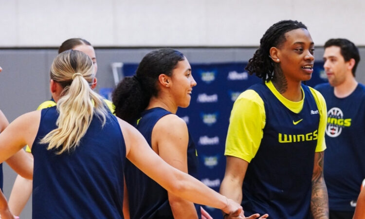 Dallas Wings guards Paige Bueckers, Azzi Fudd, and Zee Spearman on the practice court during training camp in Arlington.