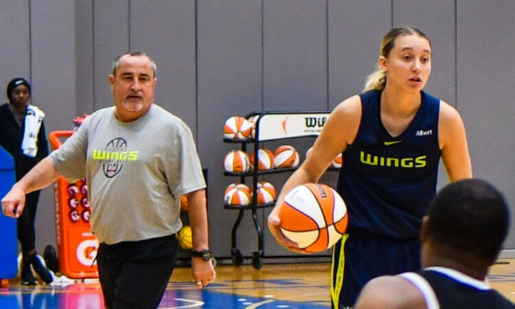 Dallas Wings star Paige Bueckers handles the ball in transition while head coach Jose Fernandez watches from the sideline at College Park Center.