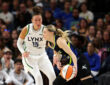 Paige Bueckers #5 of the Dallas Mavericks drives to the basket against Jessica Shepard #15 of the Minnesota Lynx at Target Center.