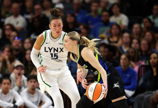 Paige Bueckers #5 of the Dallas Mavericks drives to the basket against Jessica Shepard #15 of the Minnesota Lynx at Target Center.