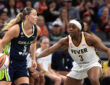 Dallas Wings guard Paige Bueckers handles the ball against Indiana Fever guard Raven Johnson.