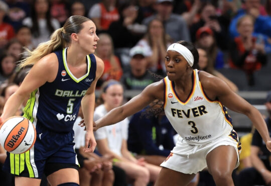 Dallas Wings guard Paige Bueckers handles the ball against Indiana Fever guard Raven Johnson.