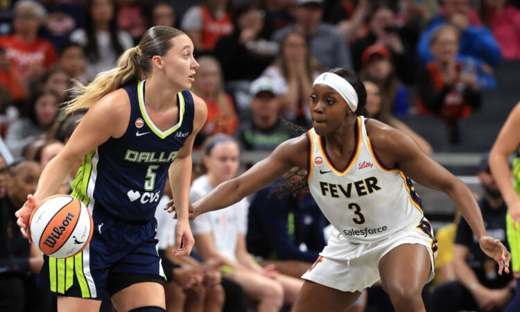 Dallas Wings guard Paige Bueckers handles the ball against Indiana Fever guard Raven Johnson.