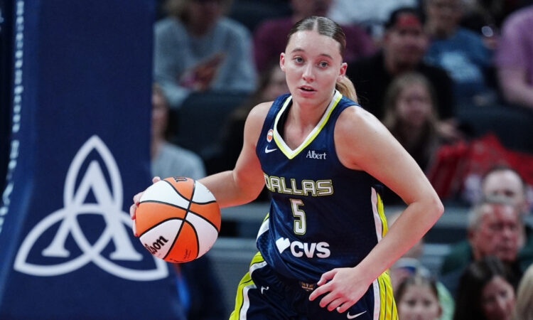 Dallas Wings guard Paige Bueckers brings the ball up court against the Indiana Fever during a preseason game at Gainbridge Fieldhouse.
