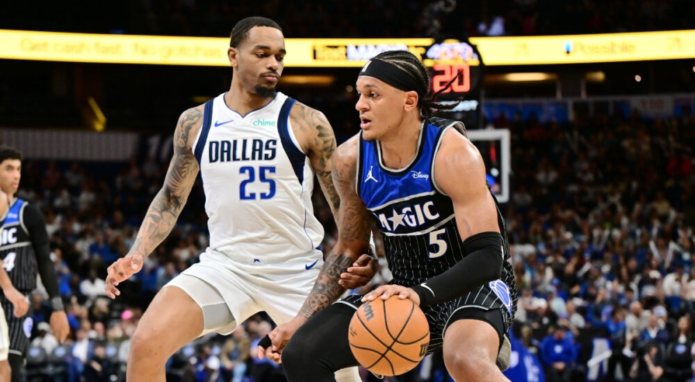 Paolo Banchero of the Orlando Magic dribbles toward the basket while being defended by P.J. Washington of the Dallas Mavericks on March 5, 2026.