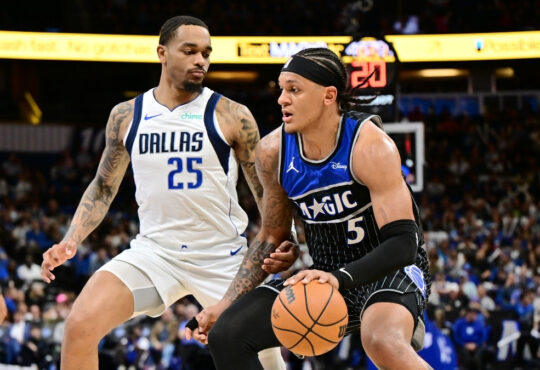 Paolo Banchero of the Orlando Magic dribbles toward the basket while being defended by P.J. Washington of the Dallas Mavericks on March 5, 2026.
