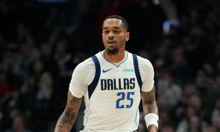 P.J. Washington #25 of the Dallas Mavericks dribbles against the Portland Trail Blazers during the first half at Moda Center on March 27, 2026.