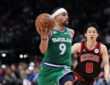 Ryan Nembhard #9 of the Dallas Mavericks drives past Yuki Kawamura #8 of the Chicago Bulls at American Airlines Center.
