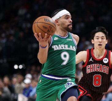 Ryan Nembhard #9 of the Dallas Mavericks drives past Yuki Kawamura #8 of the Chicago Bulls at American Airlines Center.