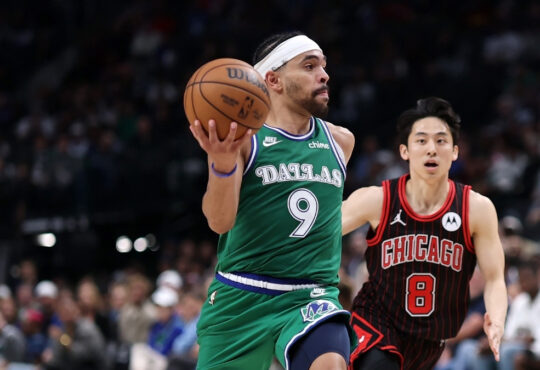 Ryan Nembhard #9 of the Dallas Mavericks drives past Yuki Kawamura #8 of the Chicago Bulls at American Airlines Center.