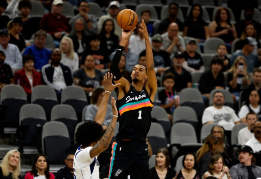 Victor Wembanyama #1 of the San Antonio Spurs attempts a three-point shot against the Dallas Mavericks at Frost Bank Center.