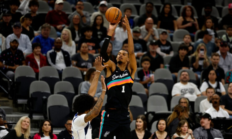 Victor Wembanyama #1 of the San Antonio Spurs attempts a three-point shot against the Dallas Mavericks at Frost Bank Center.