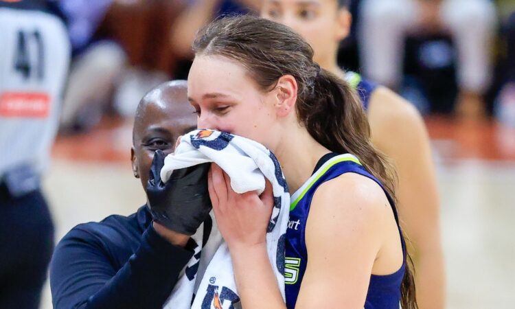 Alanna Smith of the Dallas Wings walks off the court with a facial injury during the preseason finale against the Las Vegas Aces in Austin.
