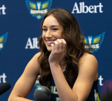 Alanna Smith of the Dallas Wings addressing reporters from the podium during the 2026 Media Day at College Park Center.