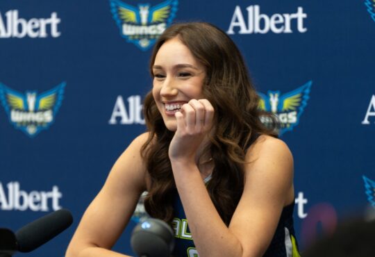 Alanna Smith of the Dallas Wings addressing reporters from the podium during the 2026 Media Day at College Park Center.