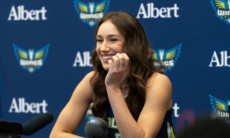 Alanna Smith of the Dallas Wings addressing reporters from the podium during the 2026 Media Day at College Park Center.