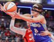 Alanna Smith (8) of the Dallas Wings reaches for a loose ball against Sophie Cunningham (8) of the Indiana Fever.