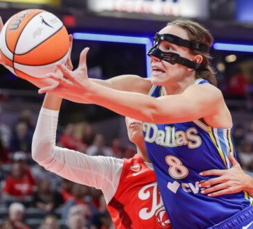 Alanna Smith (8) of the Dallas Wings reaches for a loose ball against Sophie Cunningham (8) of the Indiana Fever.