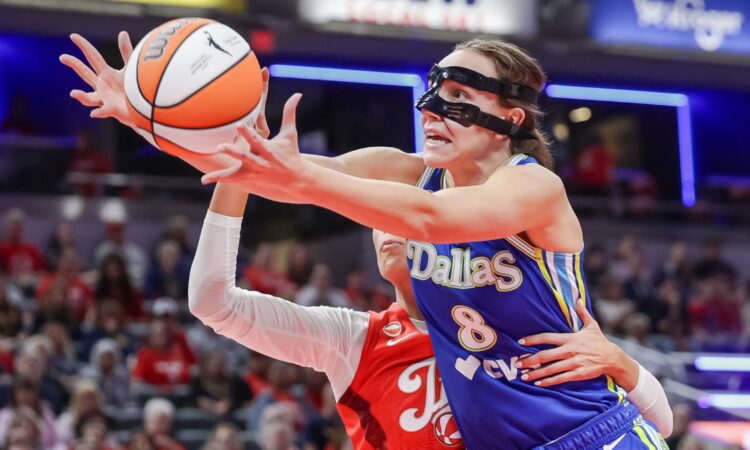 Alanna Smith (8) of the Dallas Wings reaches for a loose ball against Sophie Cunningham (8) of the Indiana Fever.