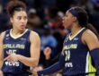Veteran guard Arike Ogunbowale and rookie guard Azzi Fudd conferring on the floor during the second half of a game against the Chicago Sky.