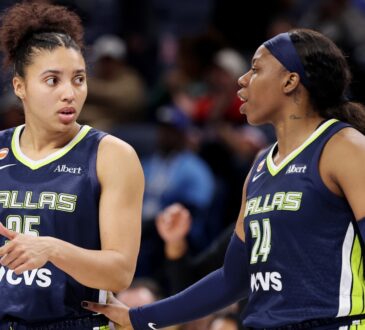 Veteran guard Arike Ogunbowale and rookie guard Azzi Fudd conferring on the floor during the second half of a game against the Chicago Sky.
