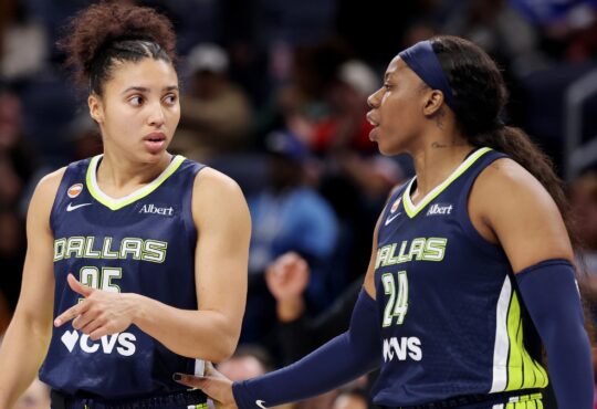 Veteran guard Arike Ogunbowale and rookie guard Azzi Fudd conferring on the floor during the second half of a game against the Chicago Sky.