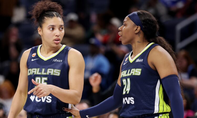 Veteran guard Arike Ogunbowale and rookie guard Azzi Fudd conferring on the floor during the second half of a game against the Chicago Sky.